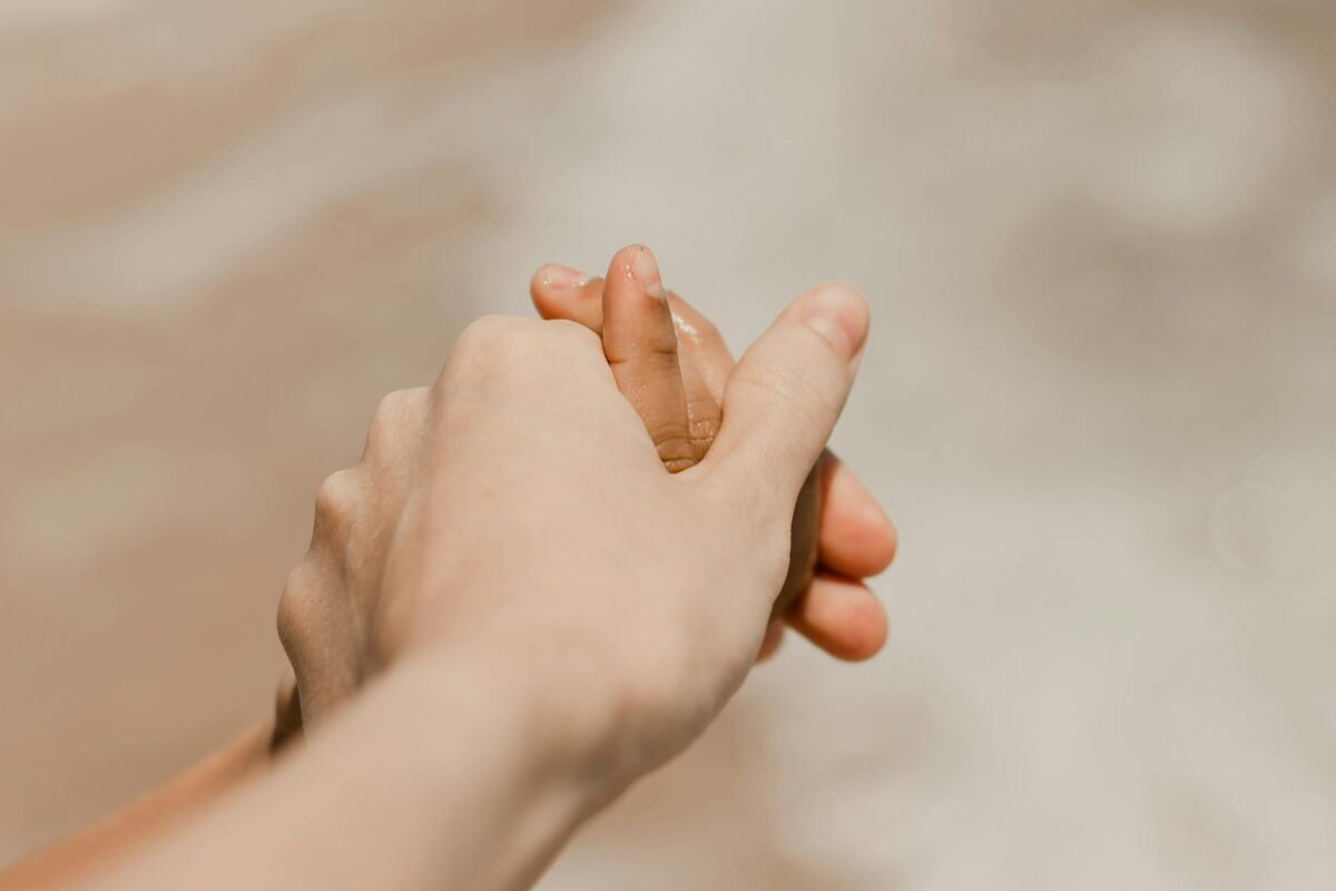 tender moment holding hands on beach