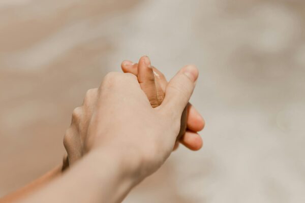 tender moment holding hands on beach